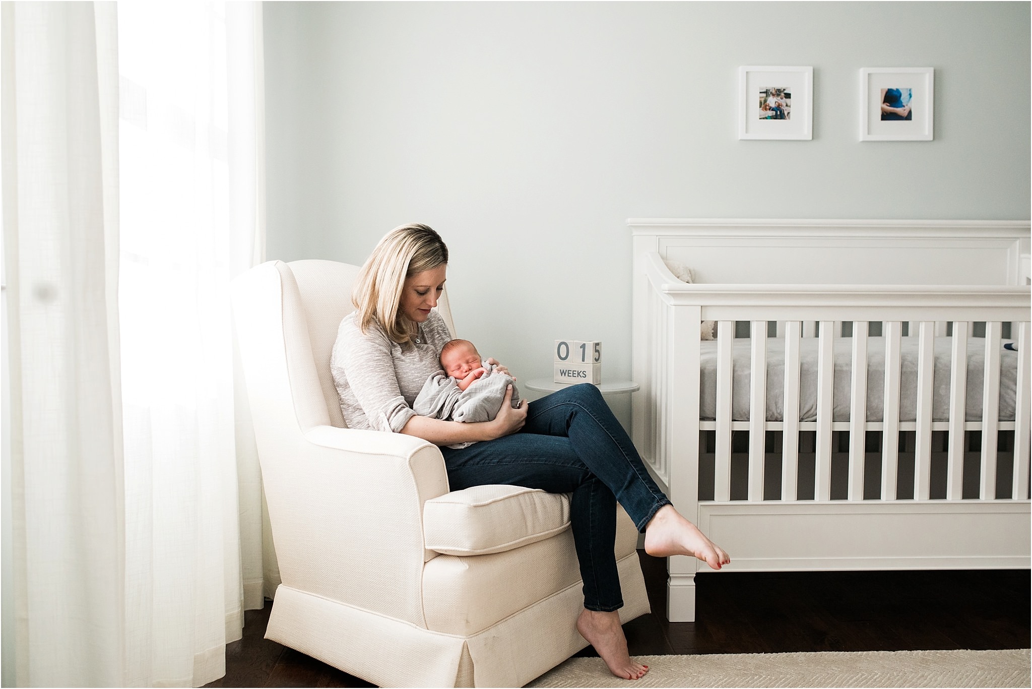 mother holding son at in home newborn session