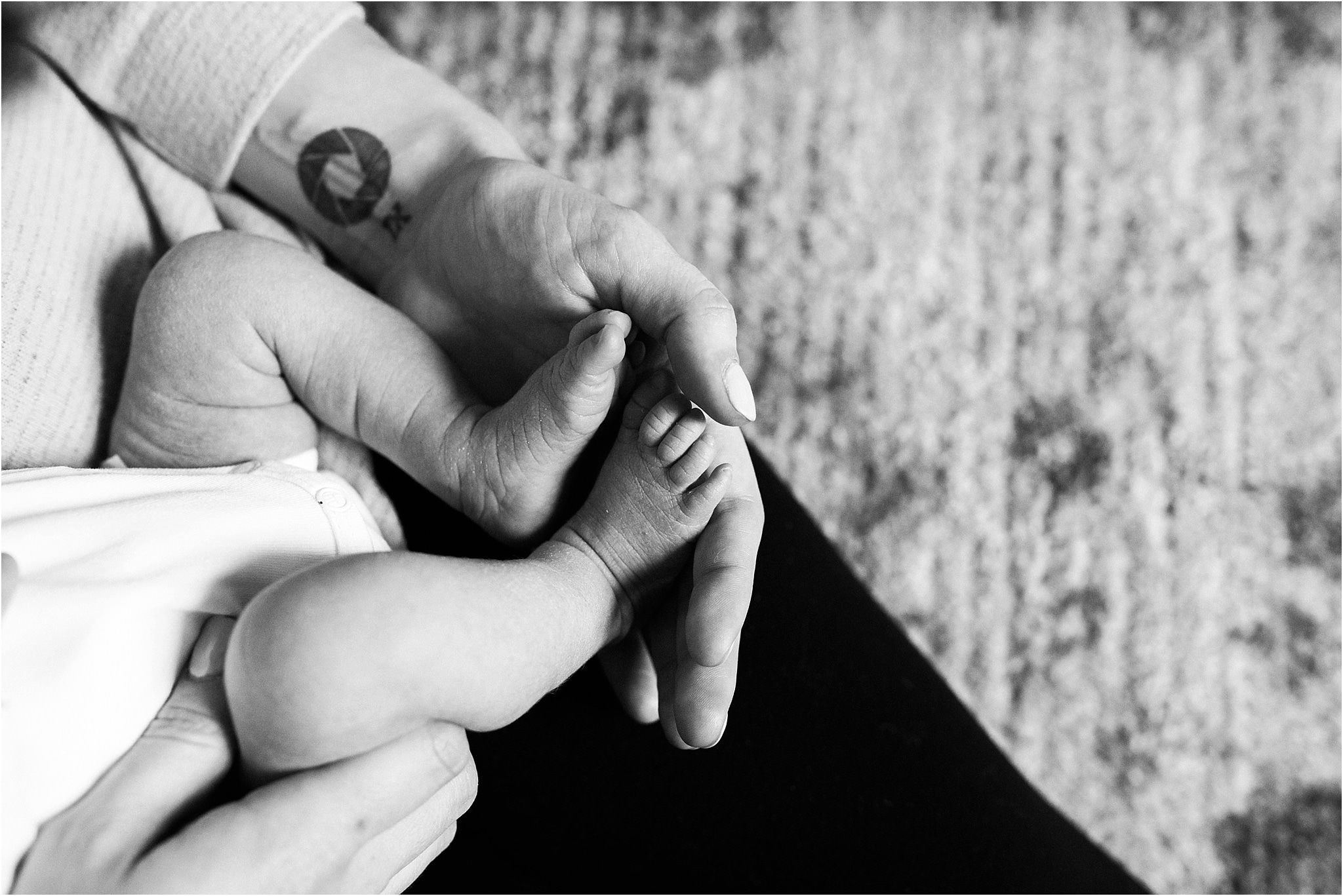 mother holding tiny newborn baby feet