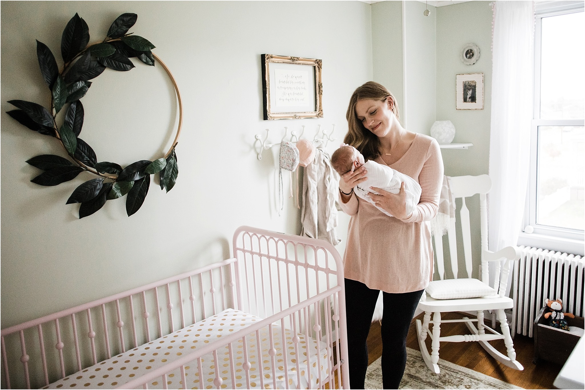 mother holding baby girl in beautiful nursery