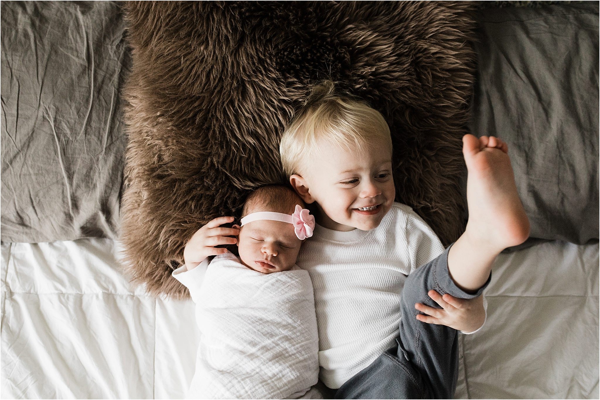 sibling photos in bedroom at newborn session at home