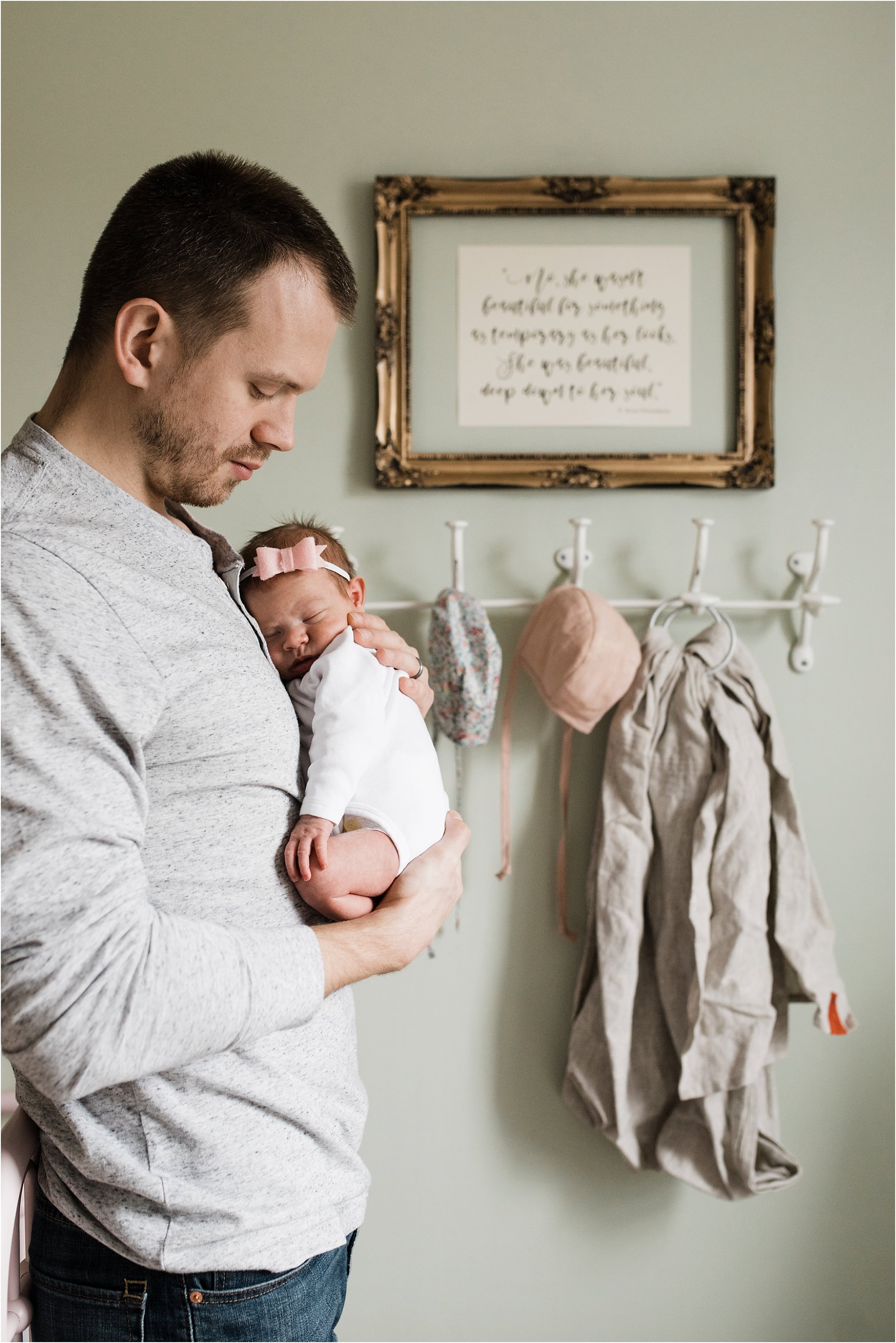 father holding baby girl in nursery