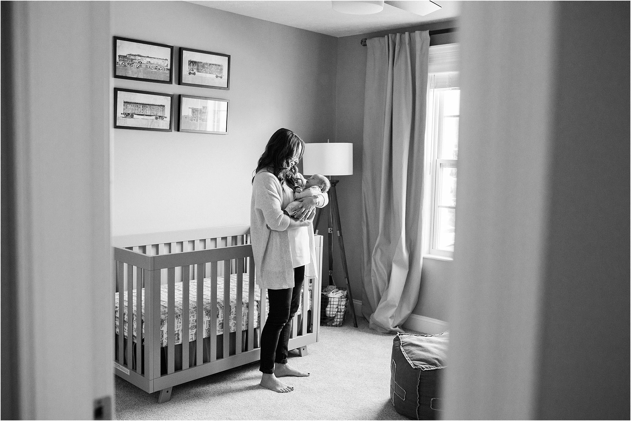 looking through doors at mother holding newborn baby