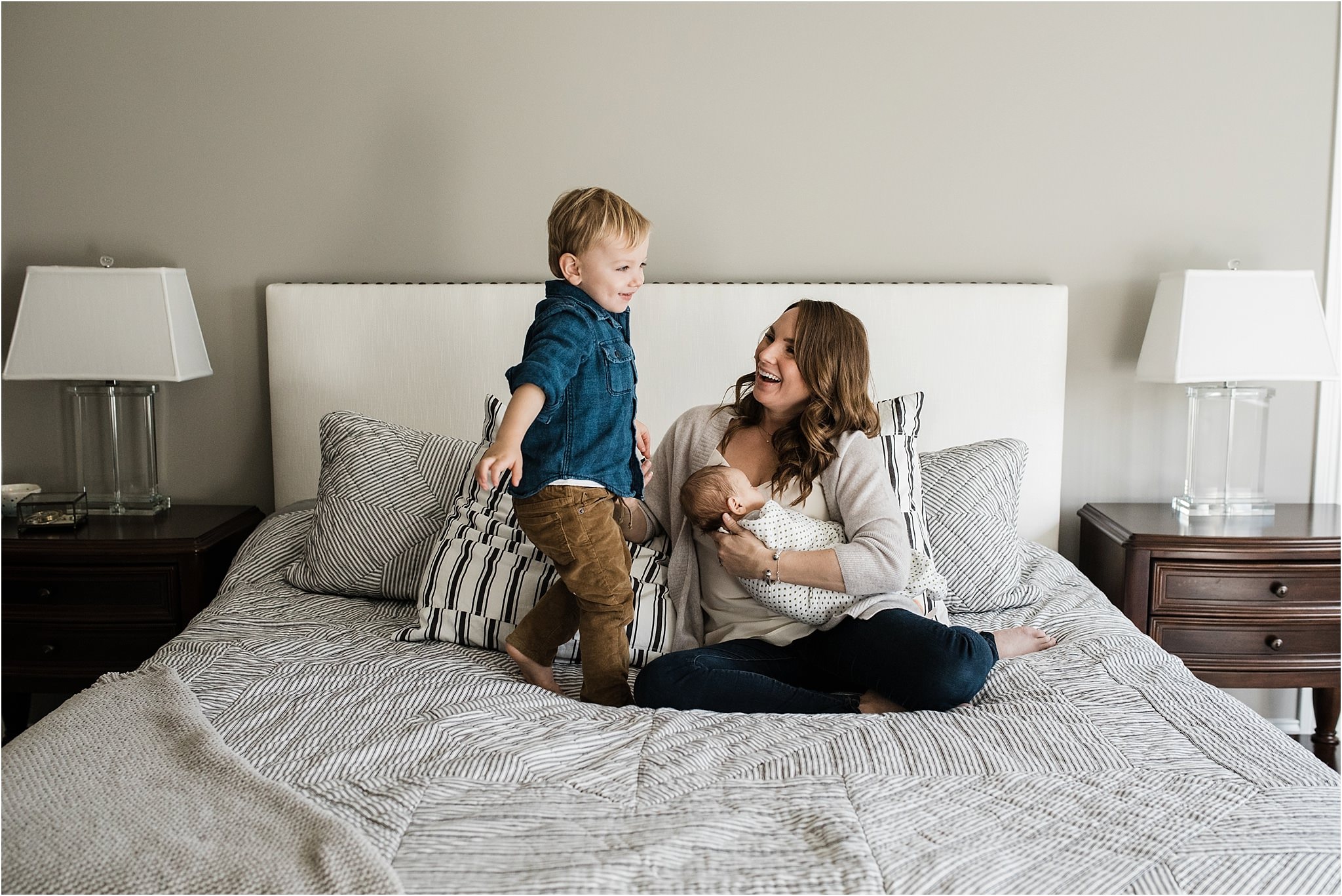 toddler having fun with mom and baby during home newborn session