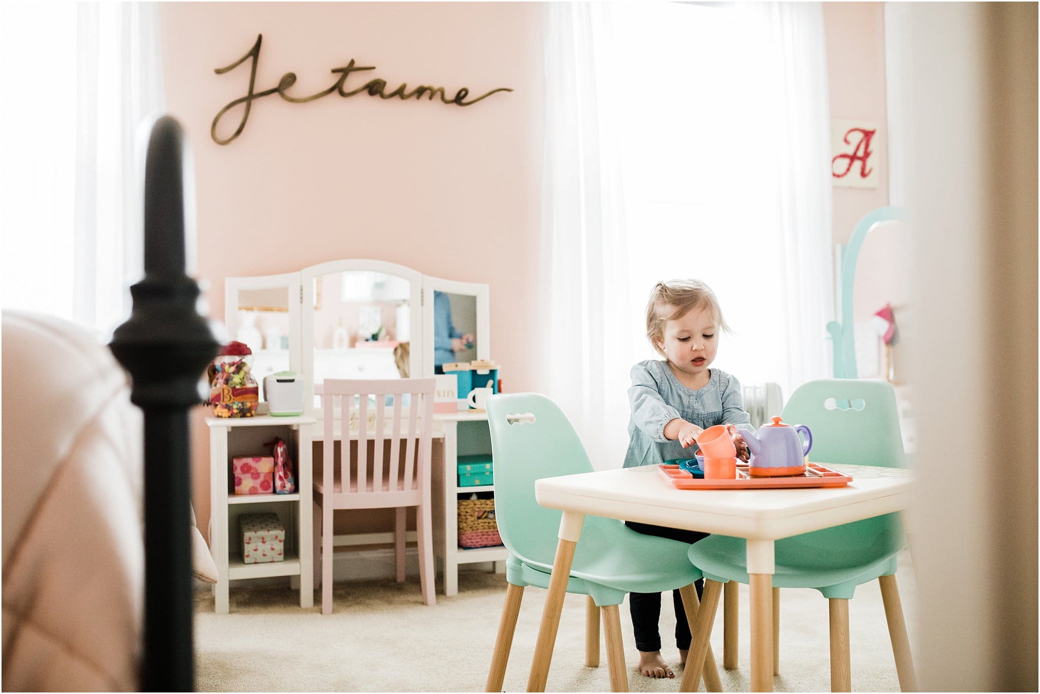 Big sister playing in room during family newborn session