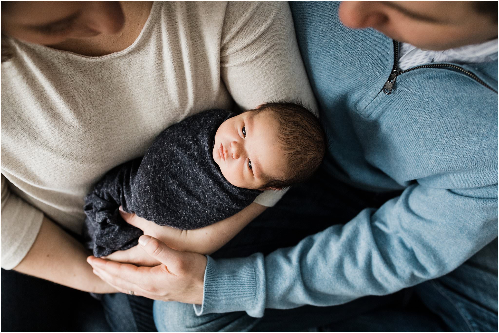 parents holding newborn baby