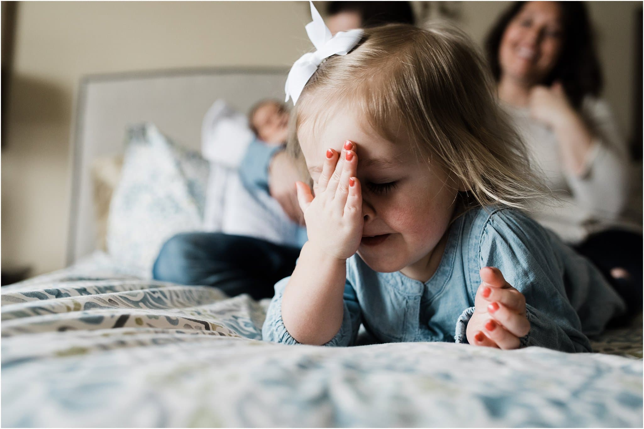 older sibling being silly at family newborn session