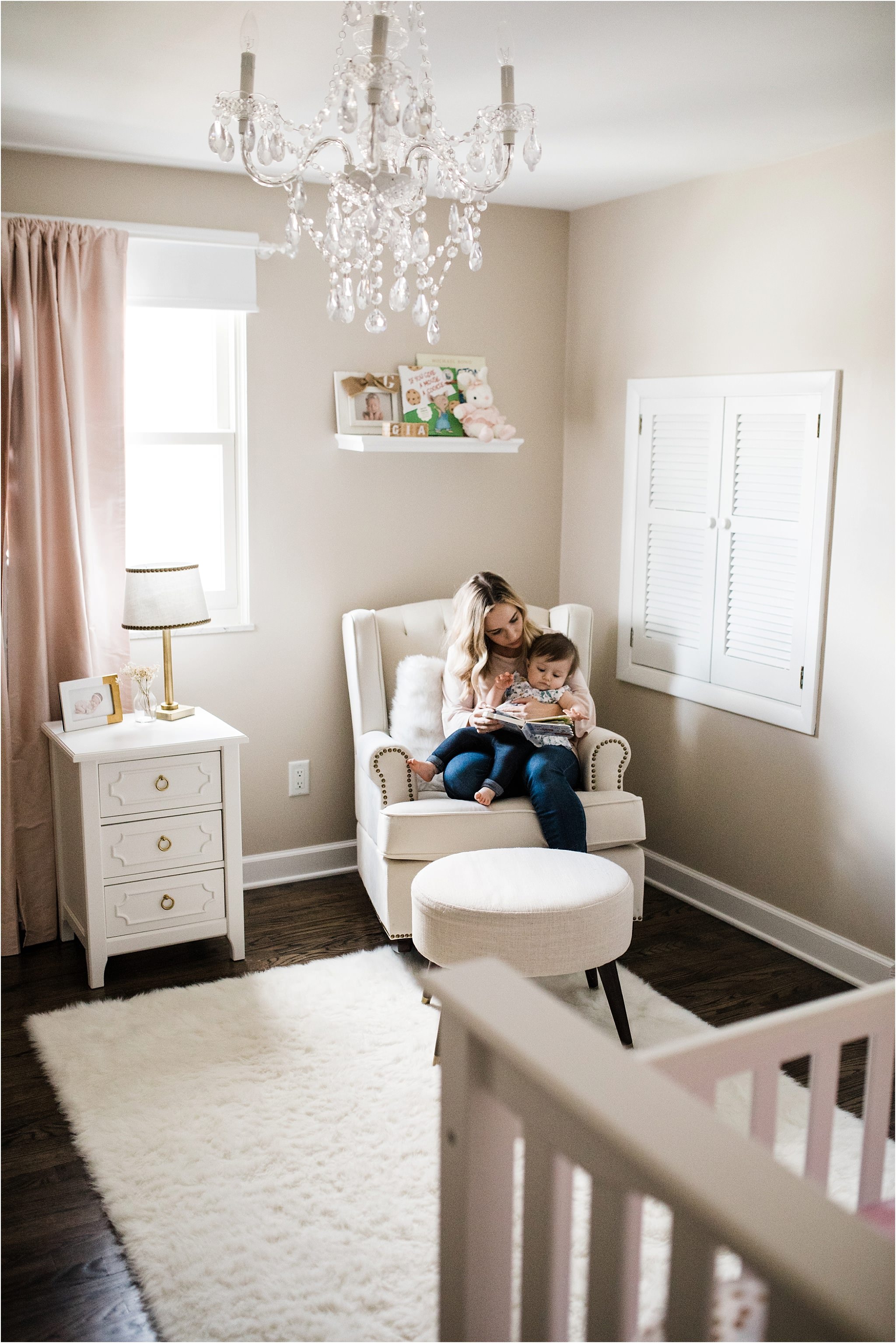 MOTHER READING TO ONE YEAR IN HER NURSERY