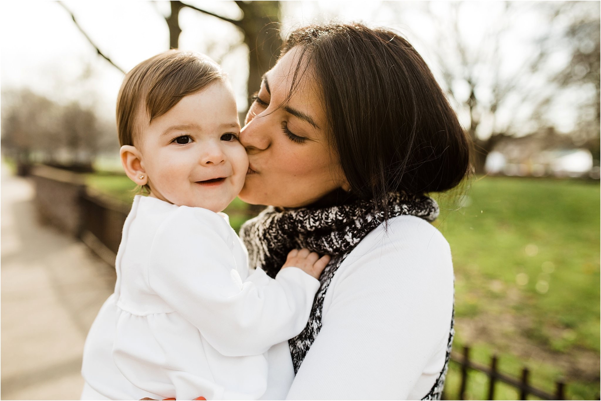 candid photo of mama kissing smiling daughter