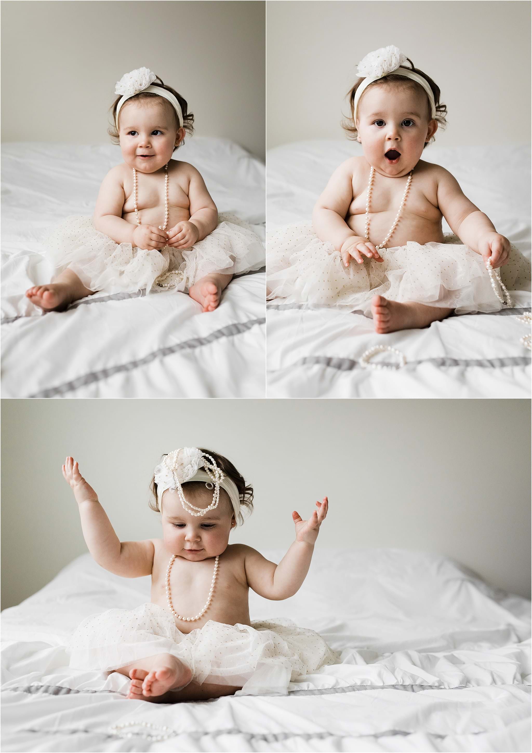 one year old girl wearing grandmothers pearls