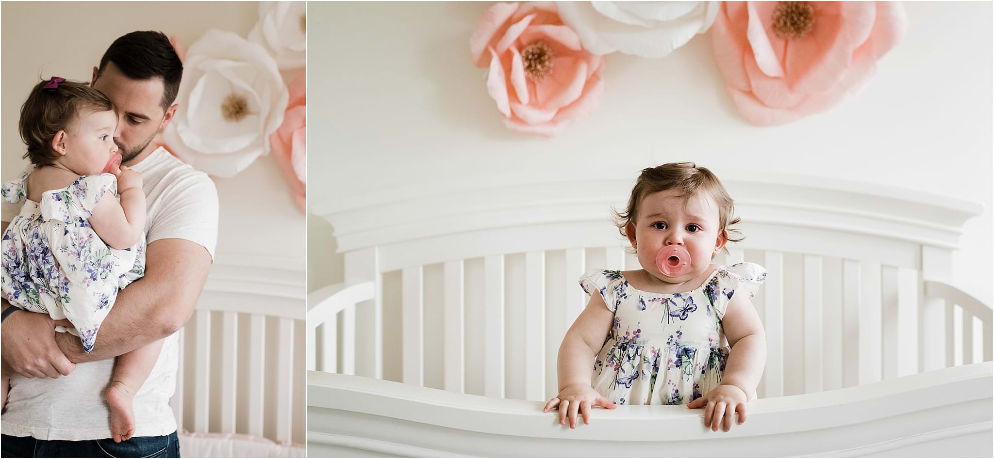 father soothing one year old daughter in nursery