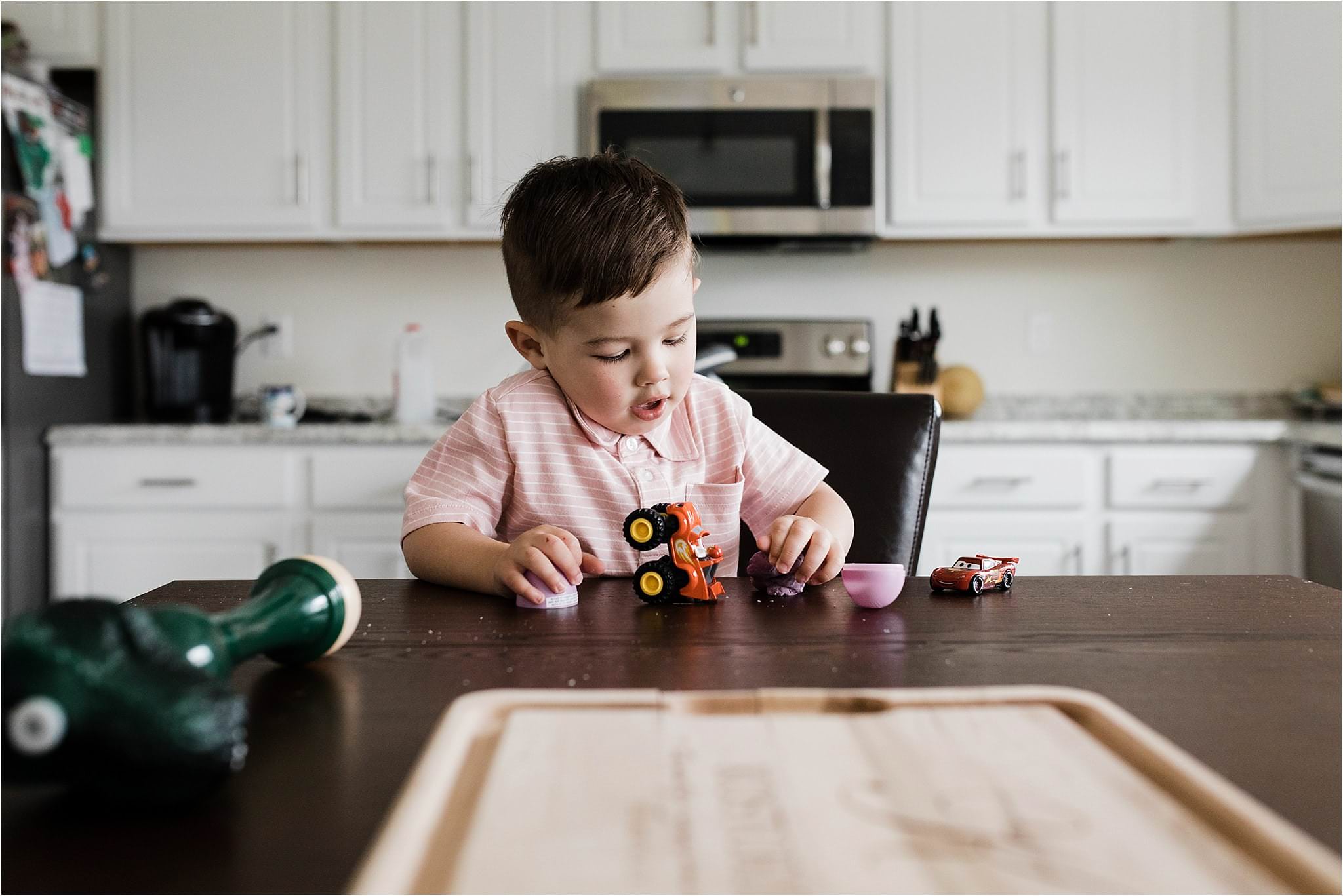 toddler boy playing at the kitchen table