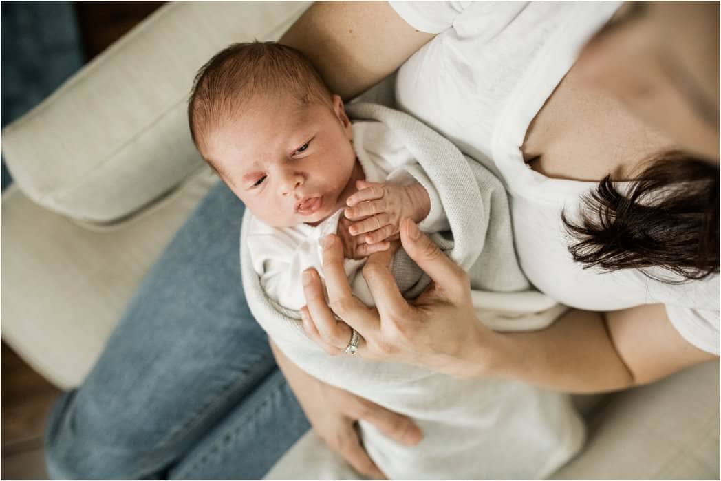 holding hands with newborn baby