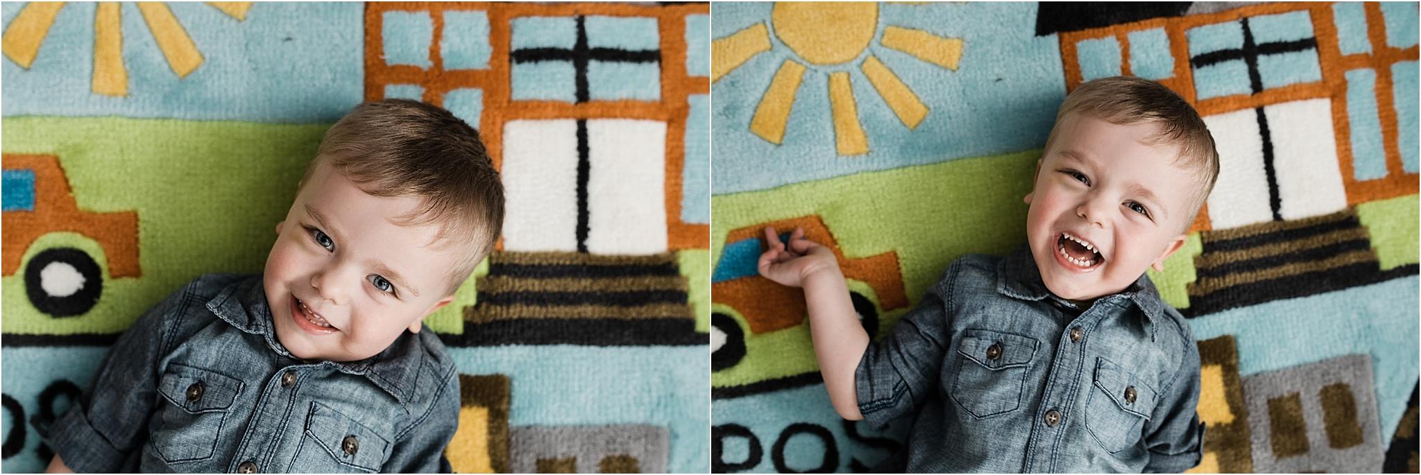 smiling and laughing toddler on fun play rug