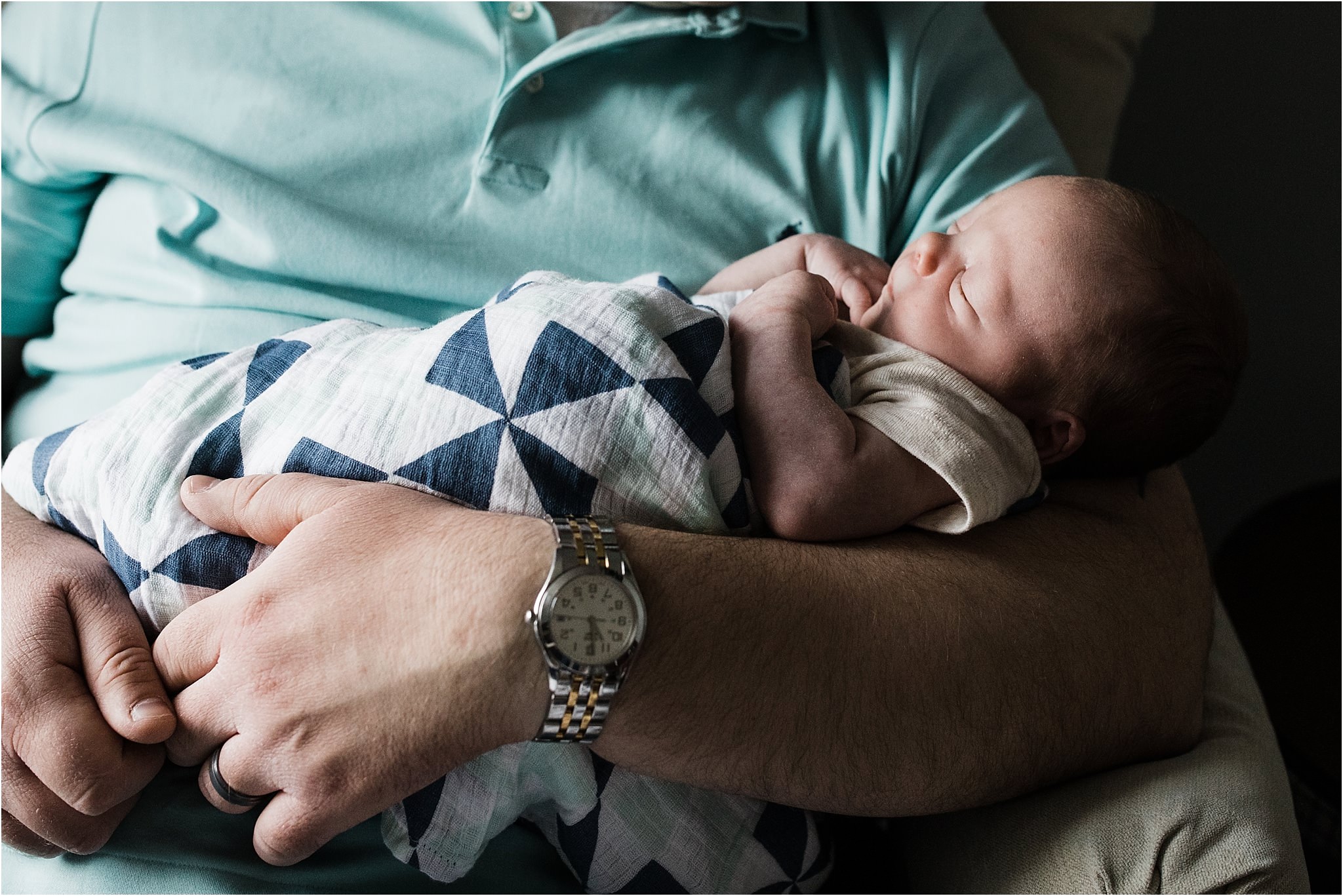 father holding newborn boy