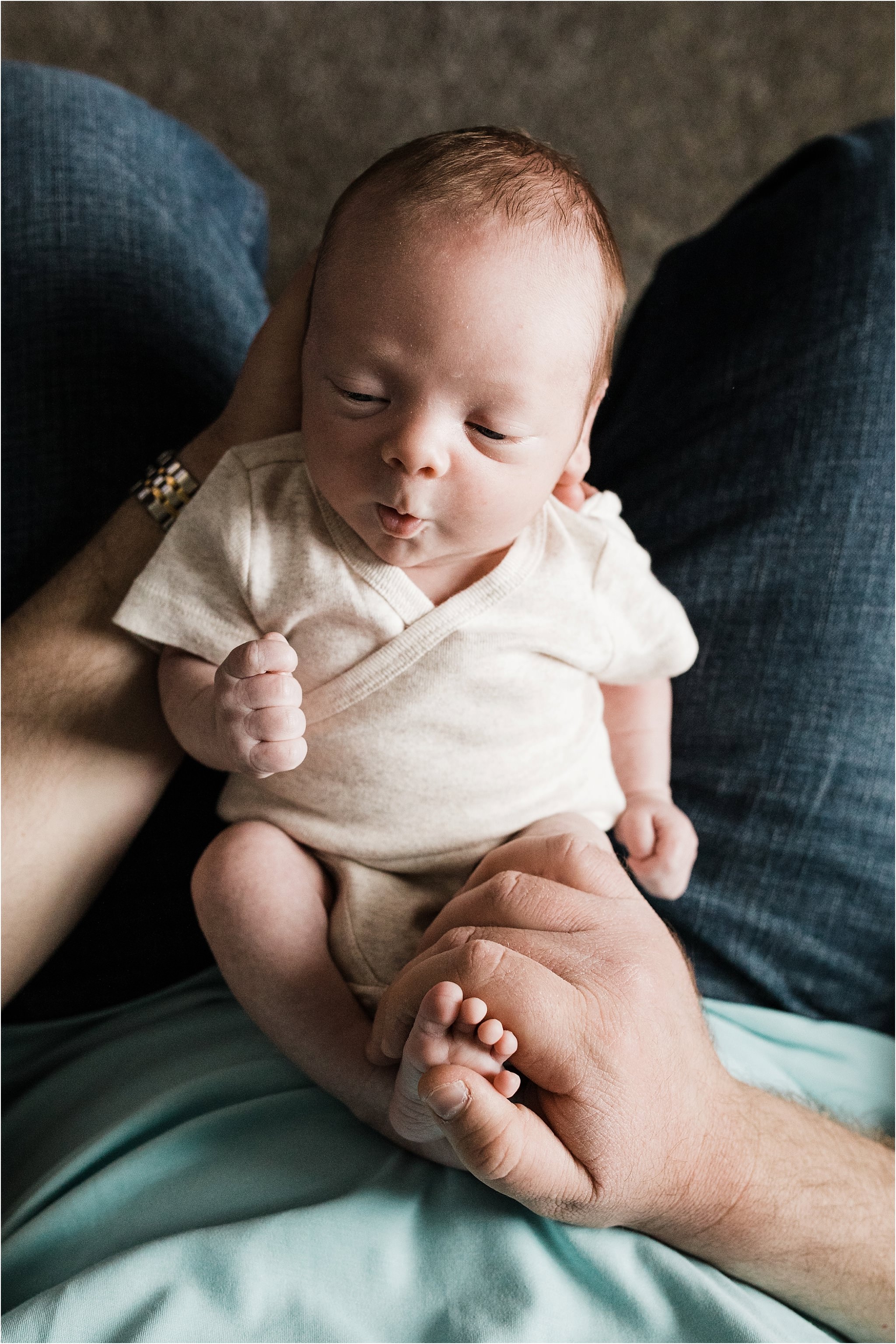 father holding newborn boy