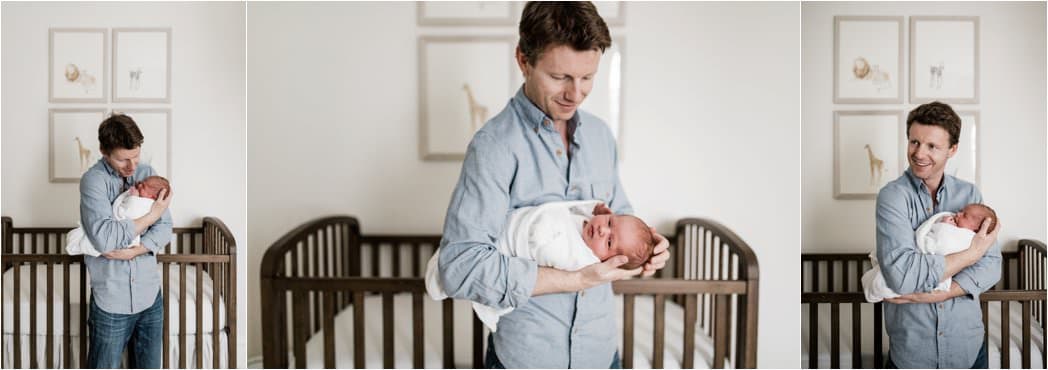 father holding baby boy in nursery