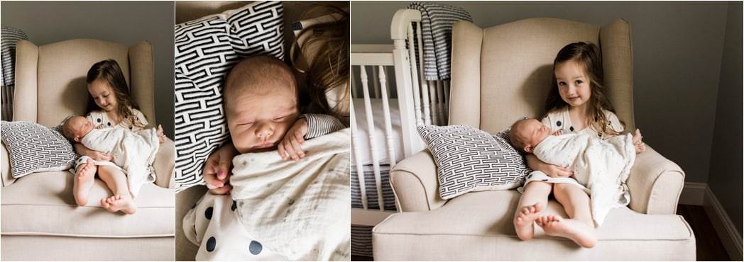 big sister loving newborn baby brother at home newborn session