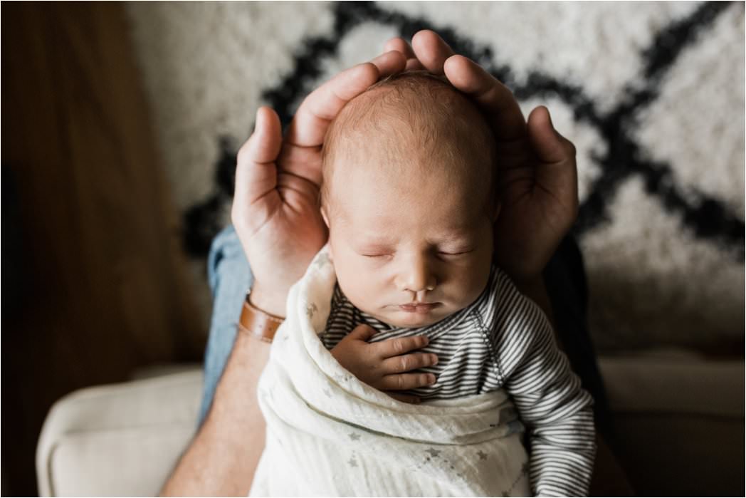 newborn baby in fathers hands