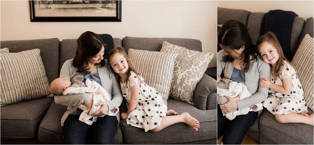 big sister snuggling mom and baby brother at home newborn session