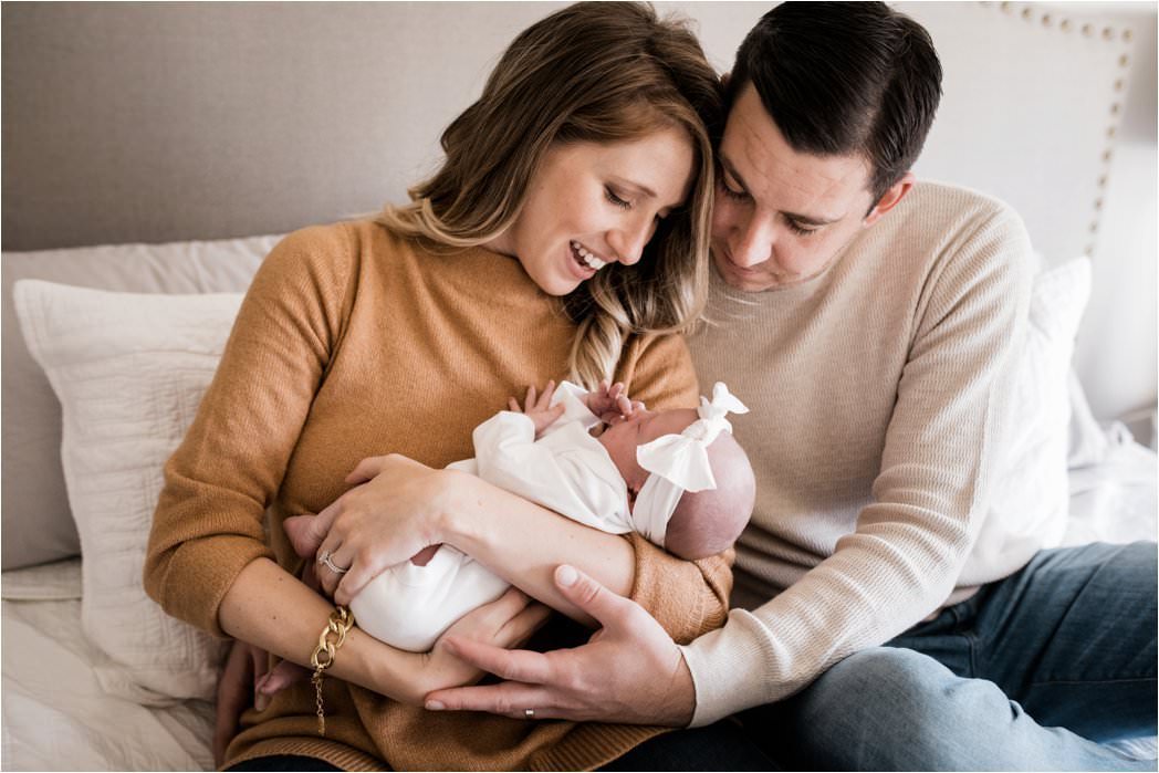 parents gazing at newborn baby girl