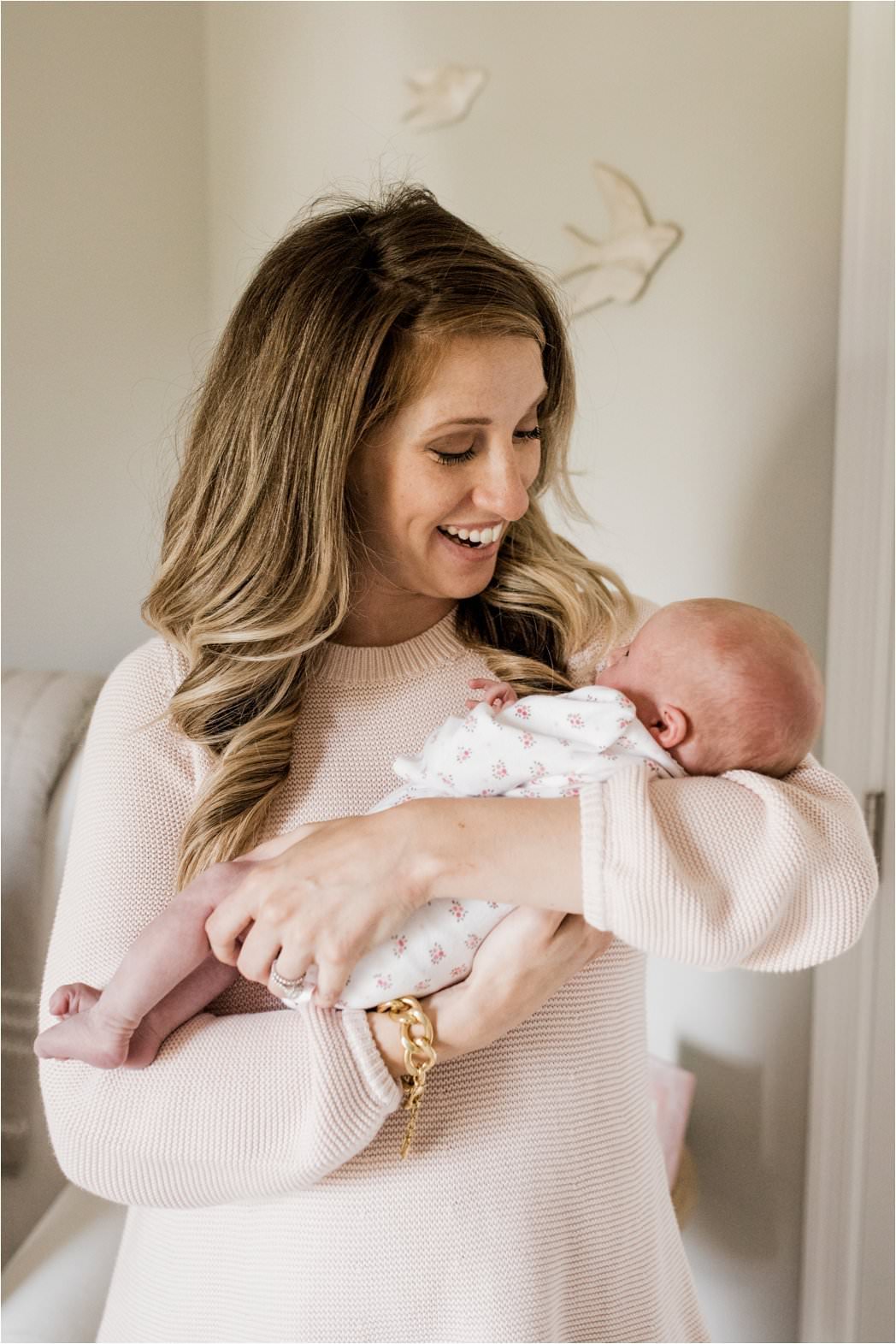 gorgeous new mother looking at her newborn baby girl