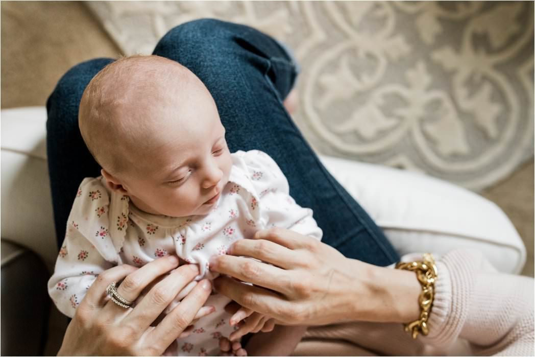 sleeping newborn baby on mamas lap