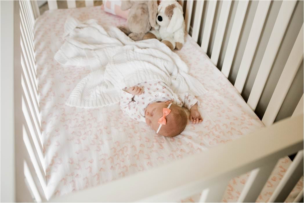 newborn baby girl sleeping in crib