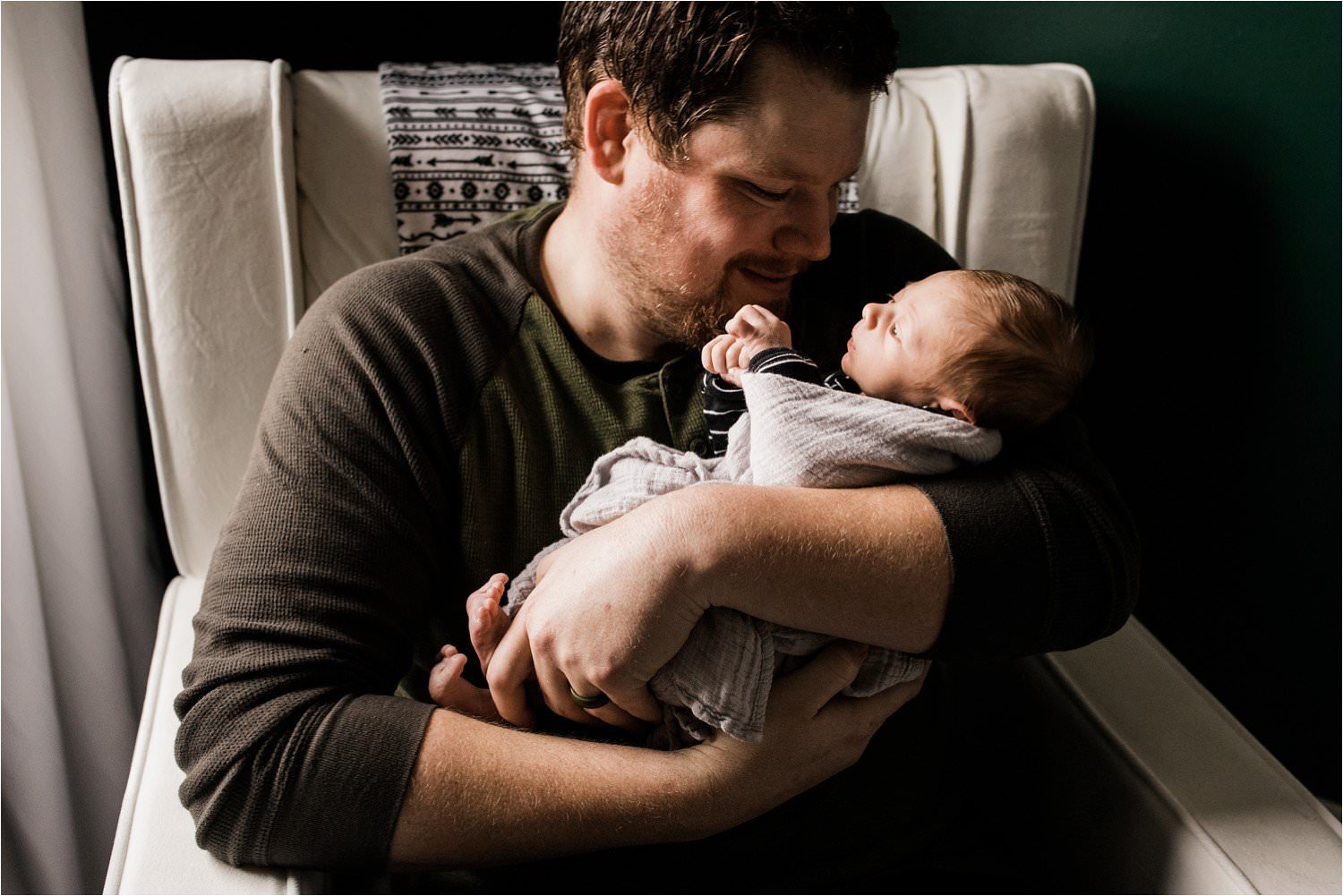 father holding newborn baby boy