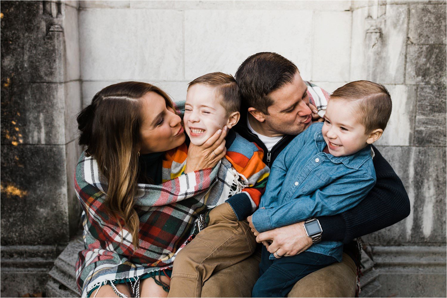 FAMILY SNUGGLED IN BLANKET AT MATERNITY SESSION