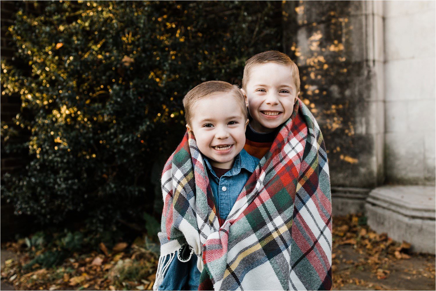 BROTHERS KEEPING WARM AT OUTDOOR FAMILY PHOTO SESSION