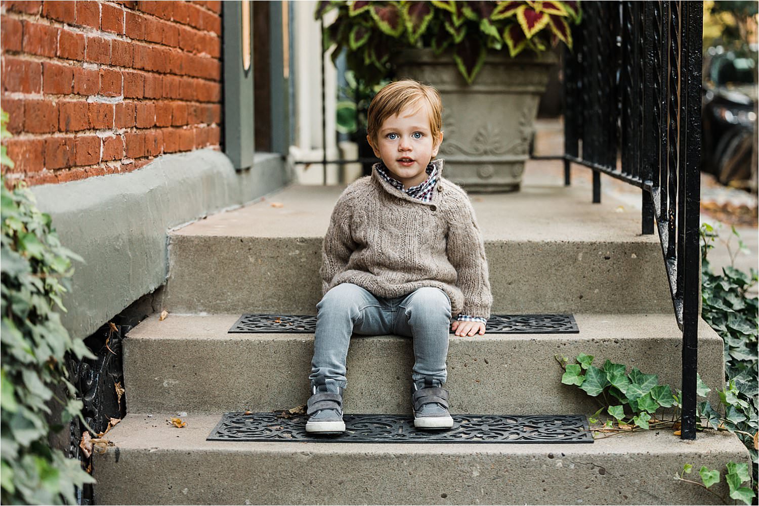 portrait of boy sitting on stoop