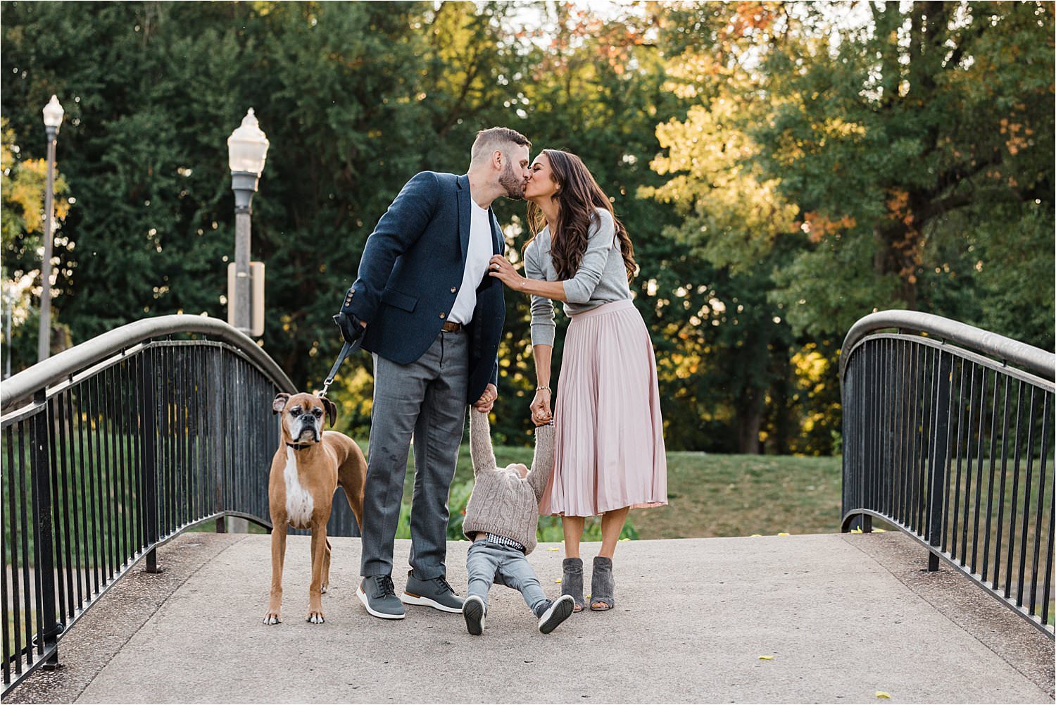 funny photo of parents kissing while child goes wild