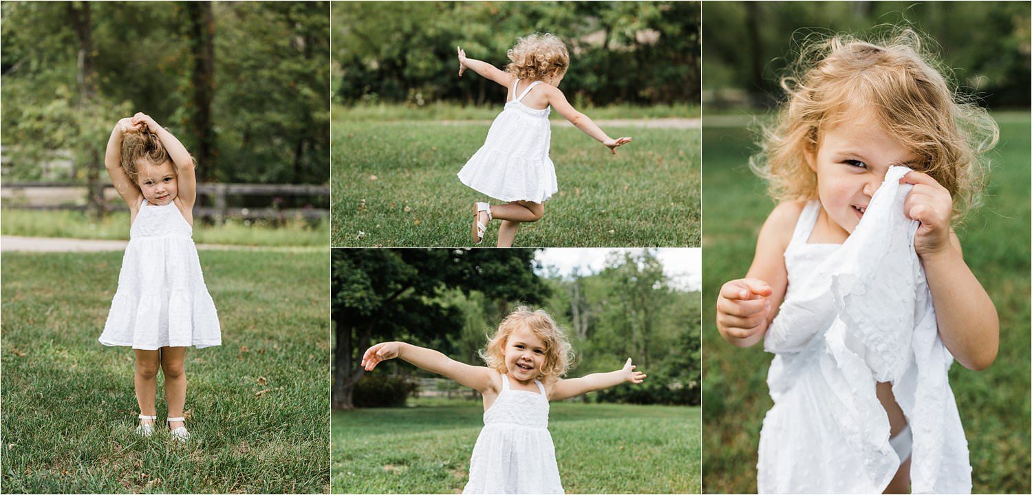natural childhood photos of little girl twirling in the grass