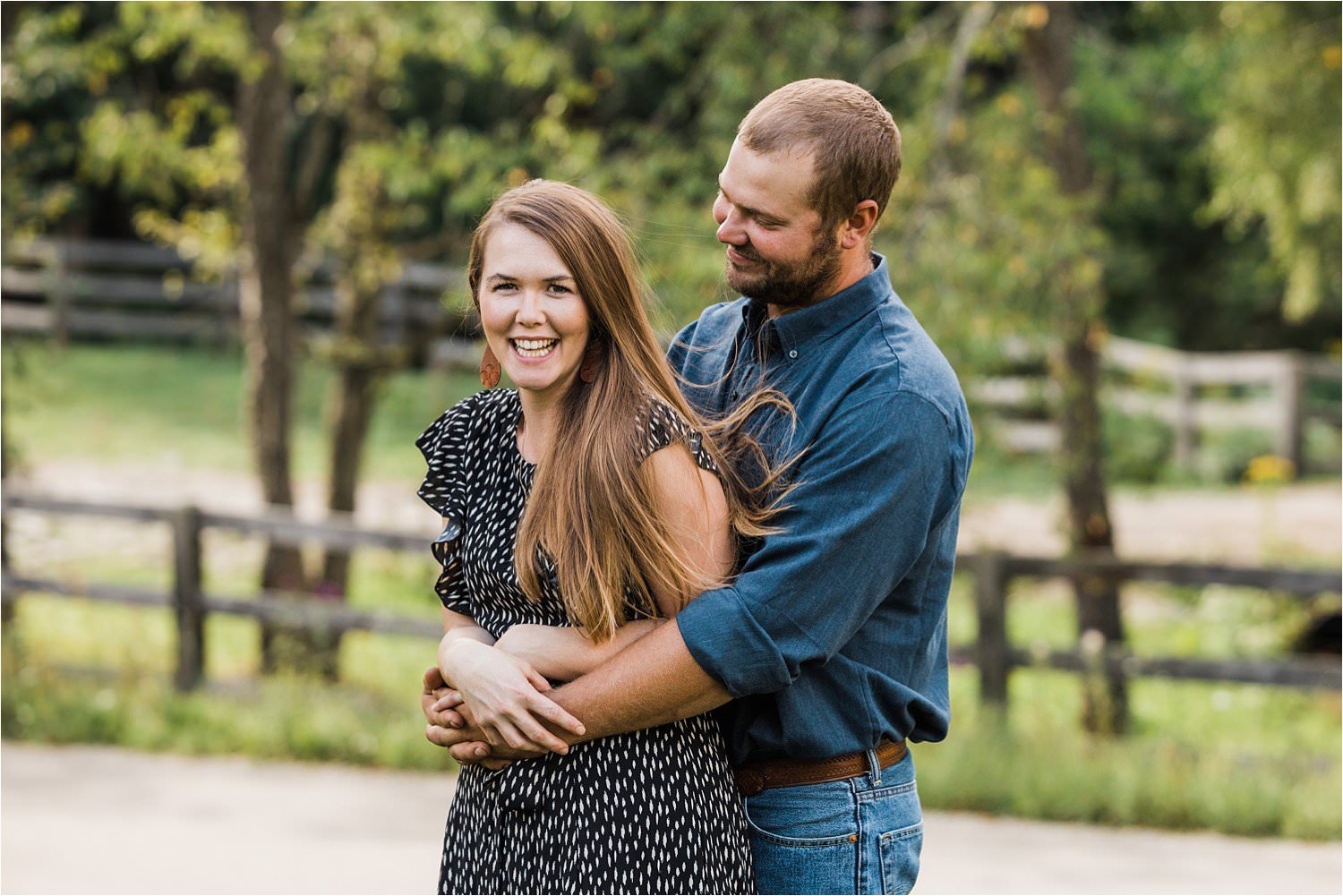 photo of a dad holding smiling mom during family photos