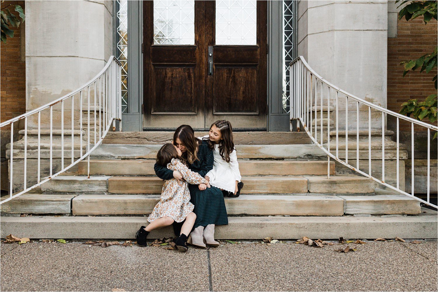 sweet mama holding her darling daughters