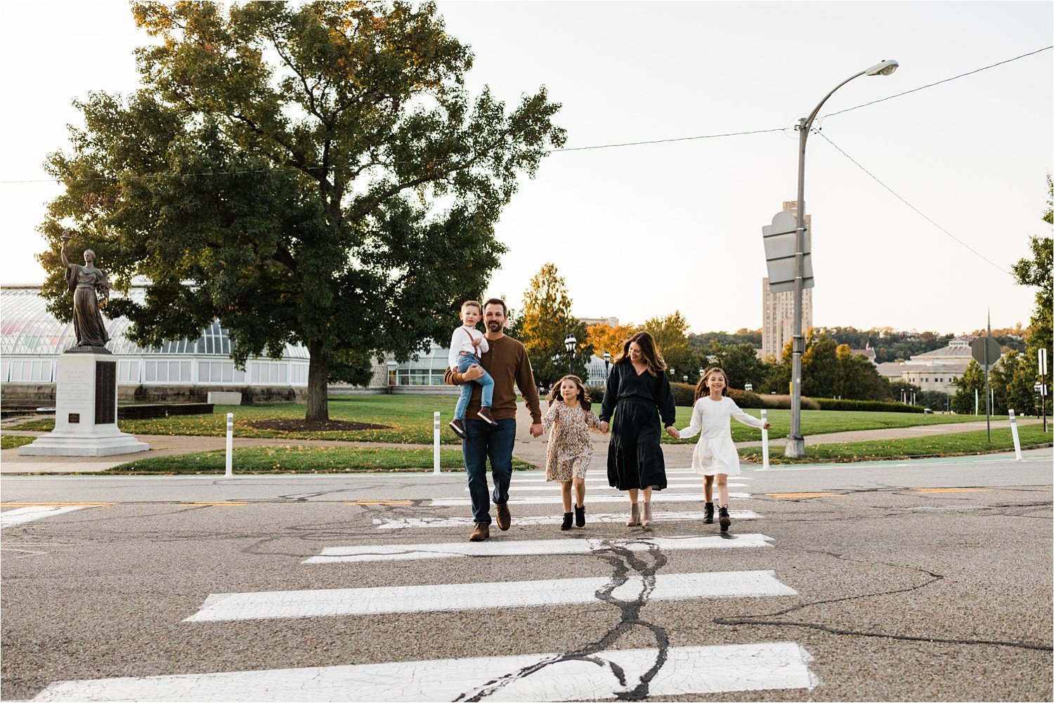 family walking in a crosswalk in pittsburghs oakland neighborhoos